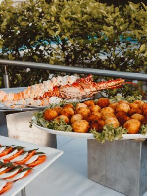 Delicious seafood and gourmet appetizers displayed on an outdoor buffet table.